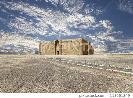 Qasr Kharana (Kharanah or Harrana)-- desert castle in eastern Jordan (100 km of Amman). Built in 8th century AD to be used as caravanserai, a resting place for traders. Against the sky with clouds Qasr Kharana (Kharanah or Harrana)-- desert castle in eastern Jordan (100 km of Amman). Built in 8th century AD to be used as caravanserai, a resting place for traders. Against the sky with clouds 118661249