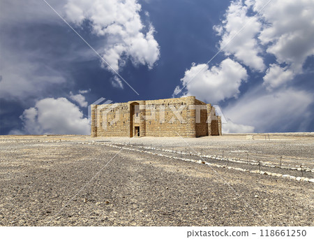 Qasr Kharana (Kharanah or Harrana)-- desert castle in eastern Jordan (100 km of Amman). Built in 8th century AD to be used as caravanserai, a resting place for traders. Against the sky with clouds Qasr Kharana (Kharanah or Harrana)-- desert castle in eastern Jordan (100 km of Amman). Built in 8th century AD to be used as caravanserai, a resting place for traders. Against the sky with clouds 118661250