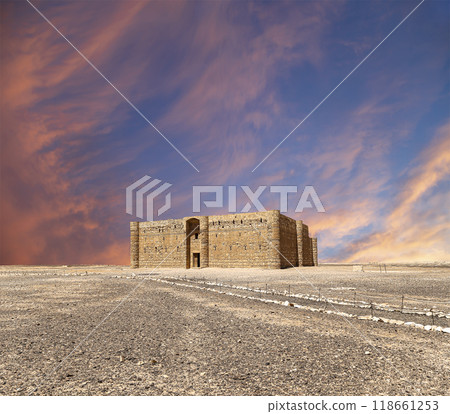 Qasr Kharana (Kharanah or Harrana)-- desert castle in eastern Jordan (100 km of Amman). Built in 8th century AD to be used as caravanserai, a resting place for traders. Against the sky with clouds Qasr Kharana (Kharanah or Harrana)-- desert castle in eastern Jordan (100 km of Amman). Built in 8th century AD to be used as caravanserai, a resting place for traders. Against the sky with clouds 118661253