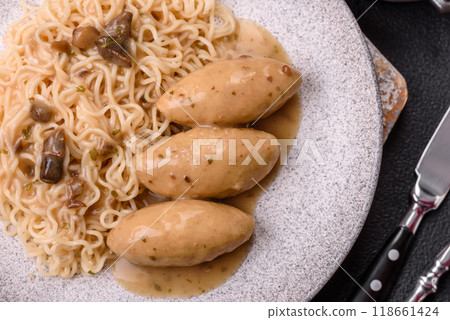 Fish or meat quenelles with vegetables, salt and spices in mushroom sauce Fish or meat quenelles with vegetables, salt and spices in mushroom sauce 118661424