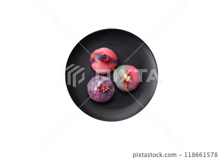 Delicious cold Japanese mochi dessert with colorful rice dough shell and fruit filling 118661578