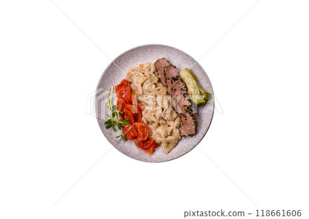 Bowl with slices of baked tuna with broccoli, tomatoes and fusili pasta 118661606