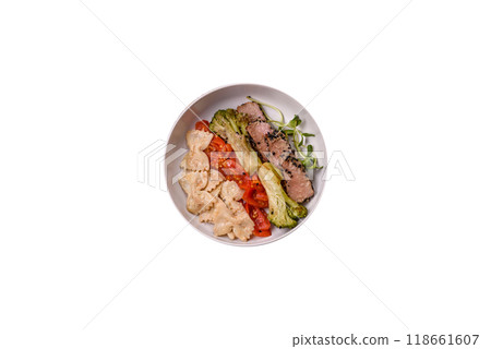 Bowl with slices of baked tuna with broccoli, tomatoes and fusili pasta Bowl with slices of baked tuna with broccoli, tomatoes and fusili pasta 118661607