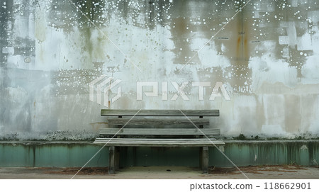 Old bench against a weathered and painted wall. 118662901