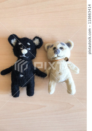 Adorable felt teddy bears on light wooden table. Handmade eco toy charming capture the essence of playful friendship. Craft and nostalgic concept 118663414