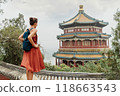 China Travel. Woman traveler relaxing enjoying travelling looking at nature view from old Chinese temple, tourist attraction in Beijing, china. Summer palace tourism destination, Asia travel 118663543