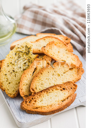 Crispy roasted bruschetta bread on cutting board. Crispy roasted bruschetta bread on cutting board. 118663693