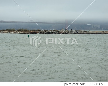 San Francisco, USA - 09.20.2024: Various pipes of a wave organ against the backdrop of the Golden Gate Bridge on a cloudy day in San Francisco, California 118663726