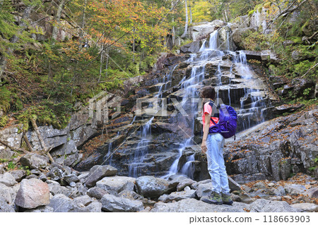 Teenager hiker enjoying Cloudland Falls at Mount Lafayette, New Hampshire, USA 118663903