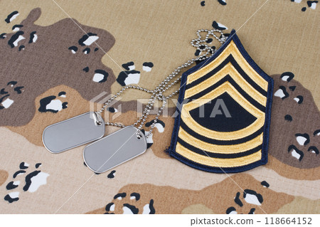 US ARMY Master Sergeant rank patch and dog tags on desert camouflage uniform background US ARMY Master Sergeant rank patch and dog tags on desert camouflage uniform background 118664152