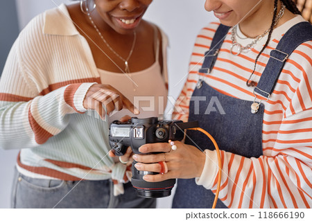Closeup of two women looking at in camera pictures model and photographer discussing pictures during photoshoot in studio Closeup of two women looking at in camera pictures model and photographer discussing pictures during photoshoot in studio 118666190