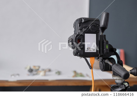 Background image of professional DSLR camera mounted on tripod in photographers studio during commercial product photoshoot copy space 118666416