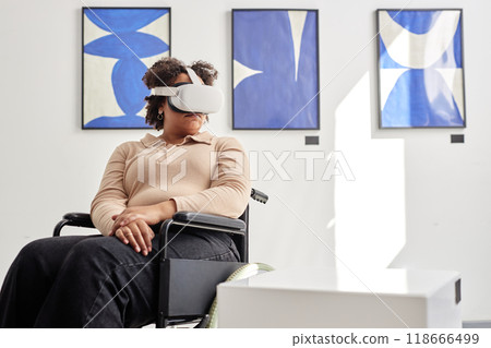 Minimal portrait of Black woman with disability using VR in modern art exhibition and looking at invisible artwork on podium copy space Minimal portrait of Black woman with disability using VR in modern art exhibition and looking at invisible artwork on podium copy space 118666499