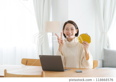 Smiling woman holding a purse Smiling woman holding a purse 118668576