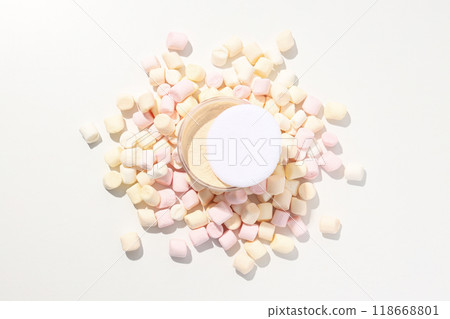 Face powder with marshmallows on a light background. Face powder with marshmallows on a light background. 118668801