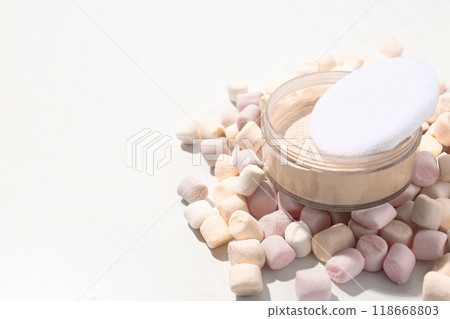 Face powder with marshmallows on a light background. Face powder with marshmallows on a light background. 118668803