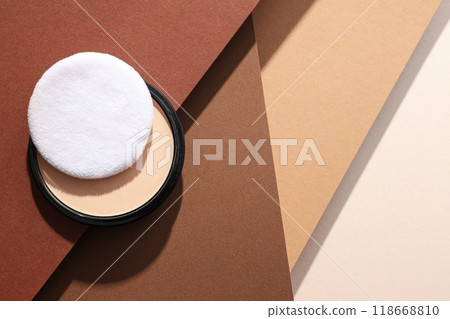 A bottle of powder, light shade, on a beige background. A bottle of powder, light shade, on a beige background. 118668810