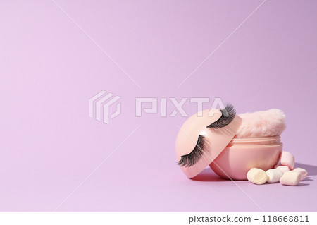 A bottle of loose powder, light shade, on a purple background. 118668811