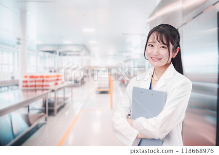 A young woman working at a food manufacturer 118668976