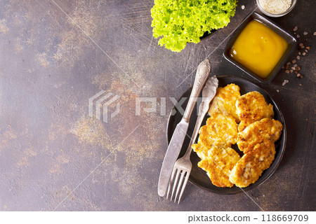 white fish cutlets on black plate 118669709