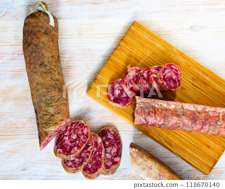 Spanish salchichon sausage cut in slices on a wooden surface 118670140