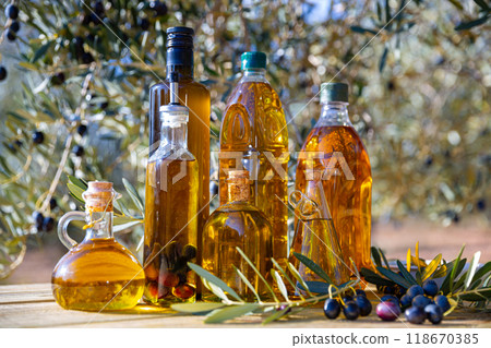 Various kinds of oil on the table on background of olive tree 118670385