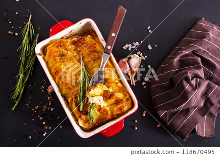 Potato gratin - graten (baked potatoes with cream and cheese) . 118670495