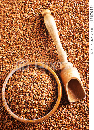 Wooden bowl full of raw wholegrain buckwheat groats Wooden bowl full of raw wholegrain buckwheat groats 118670554