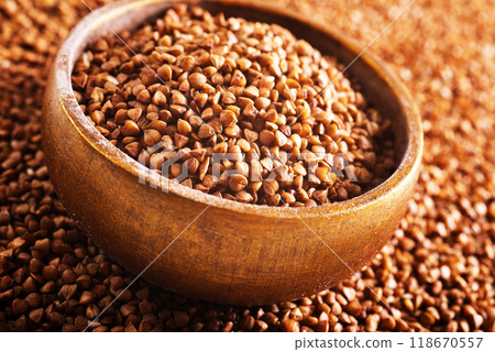 Wooden bowl full of raw wholegrain buckwheat groats Wooden bowl full of raw wholegrain buckwheat groats 118670557