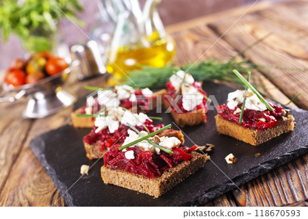 Baked beet on bread, with cheese and walnuts Baked beet on bread, with cheese and walnuts 118670593