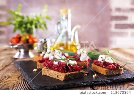 Baked beet on bread, with cheese and walnuts Baked beet on bread, with cheese and walnuts 118670594