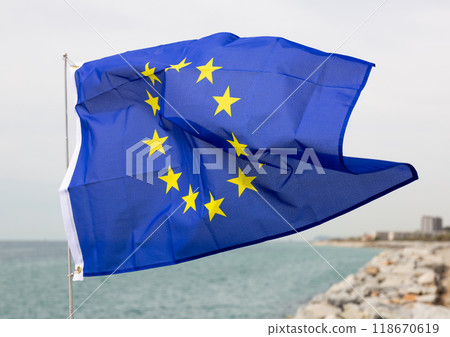 Flag of European Union fluttering against backdrop of sea Flag of European Union fluttering against backdrop of sea 118670619