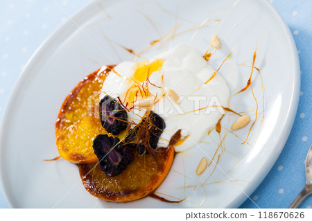 Dessert with caramelized oranges, yogurt, brambleberries 118670626