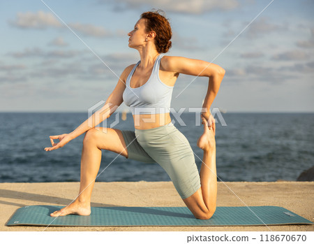 Portrait of sporty woman practicing various yoga poses on seashore Portrait of sporty woman practicing various yoga poses on seashore 118670670