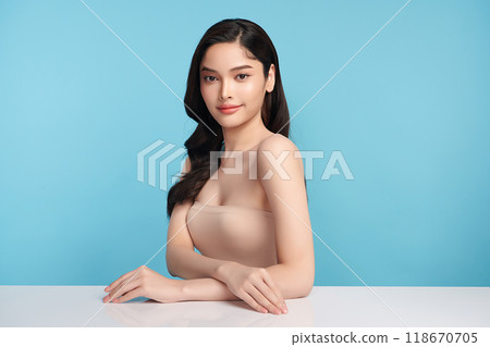 Beautiful young asian woman with clean fresh skin on blue background, Face care, Facial treatment, Cosmetology, beauty and spa, Asian women portrait. Beautiful young asian woman with clean fresh skin on blue background, Face care, Facial treatment, Cosmetology, beauty and spa, Asian women portrait. 118670705