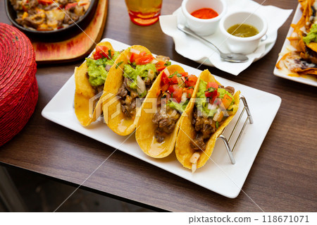 Mexican food tasty tacos with beef, guacamole sauce 118671071