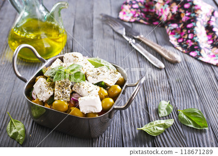 Greek salad with tomatoes, feta cheese, cucumbers, onions and olives 118671289