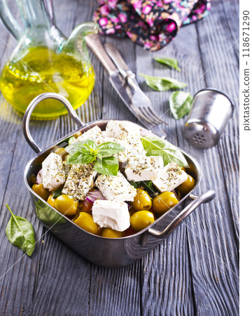 Greek salad with tomatoes, feta cheese, cucumbers, onions and olives 118671290