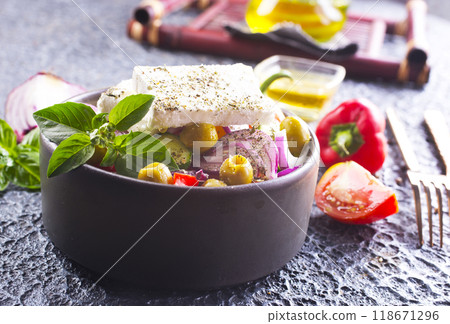 Greek salad with tomatoes, feta cheese, cucumbers, onions and olives 118671296