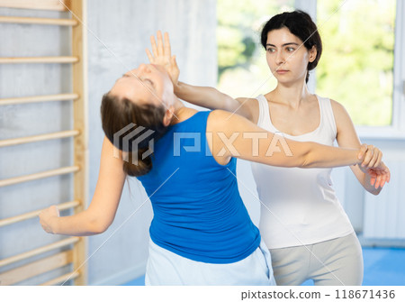 women trained in executing powerful palm punch women trained in executing powerful palm punch 118671436