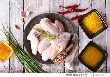 Raw chicken wings, herbs and spices with pepper chili tomato garlic for cooking thai asian food rosemary chicken, top view. Raw chicken wings, herbs and spices with pepper chili tomato garlic for cooking thai asian food rosemary chicken, top view. 118671618