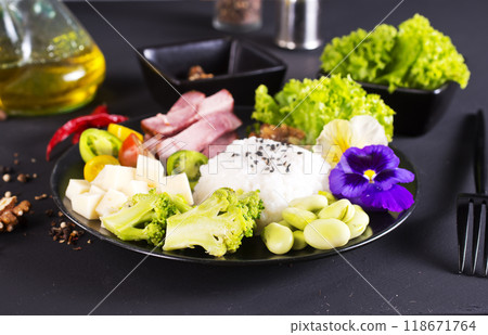 Rice and broccoli served on a plate on dark background Rice and broccoli served on a plate on dark background 118671764