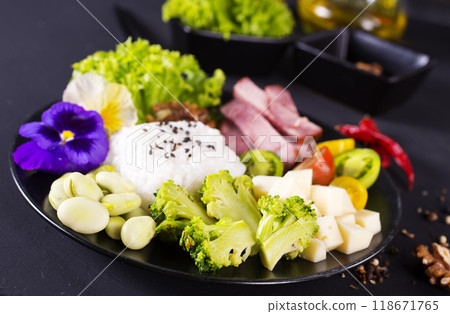 Rice and broccoli served on a plate on dark background 118671765