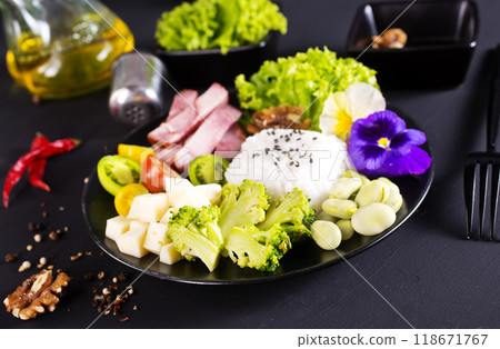 Rice and broccoli served on a plate on dark background 118671767