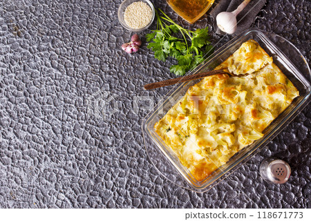 Cauliflower cheese in a baking dish on stone table Cauliflower cheese in a baking dish on stone table 118671773