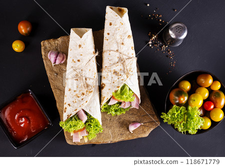 wrap sandwich with ham, lettuce, tomatoes and cheeses 118671779
