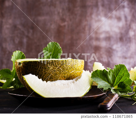 Honey melon on a table. 118671865