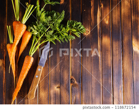 Orange and yellow carrots on a table Orange and yellow carrots on a table 118672154