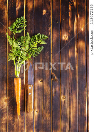 Orange and yellow carrots on a table 118672156