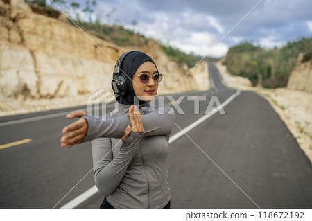 young woman wearing sportswear stretching before workout 118672192